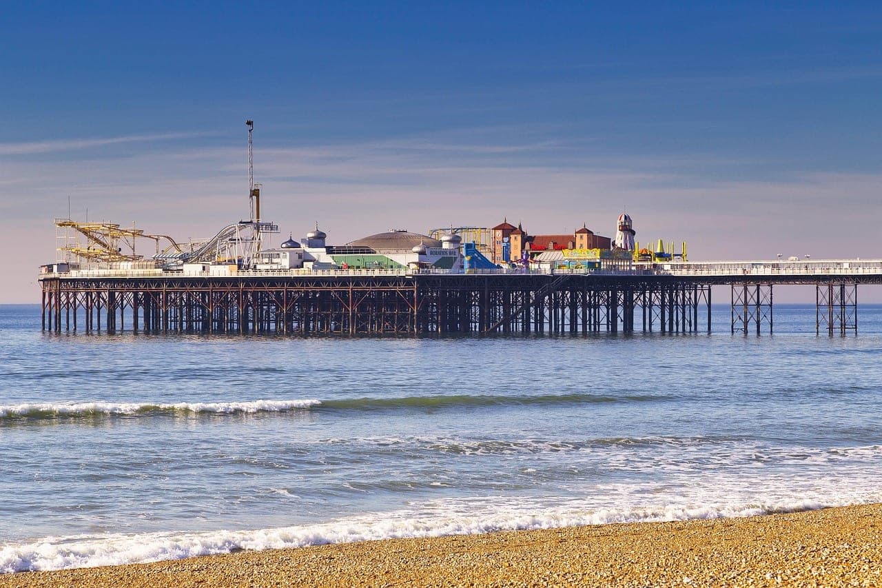 Brighton Palace Pier and pebble beach along the Brighton seafront in England